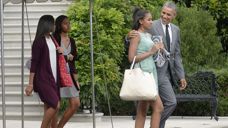 Barack Obama, Sasha Obama and two of Sasha's friends walking