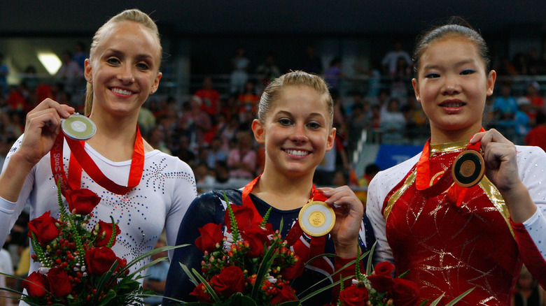 Shawn Johnson holding gold medal