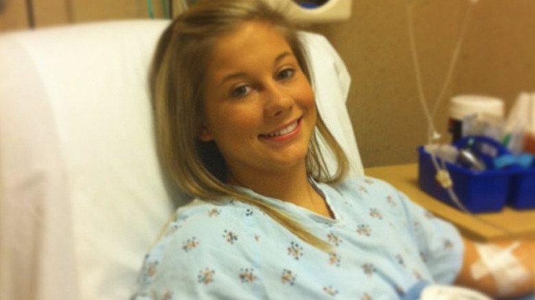Shawn Johnson looks at camera in hospital bed