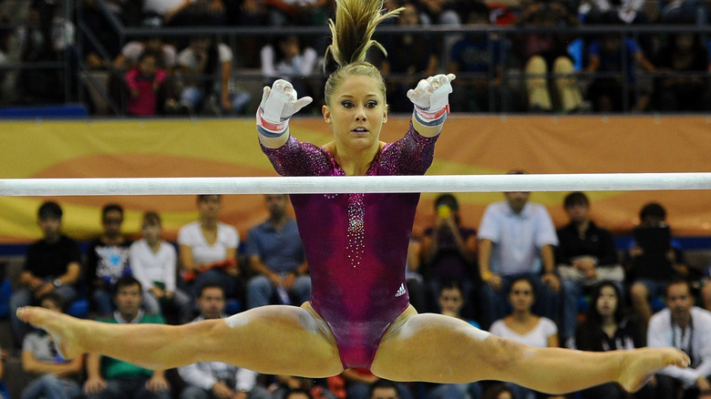 Shawn Johnson reaching for bar