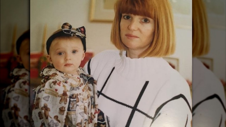 Sophie Turner as baby being held by her mother