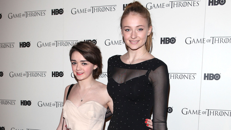 Maisie Williams with arm around Sophie Turner