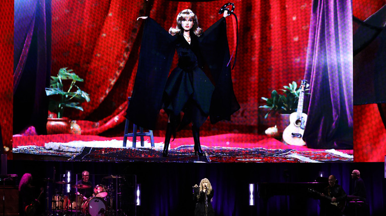 Stevie Nicks with backdrop of Stevie Nicks Barbie