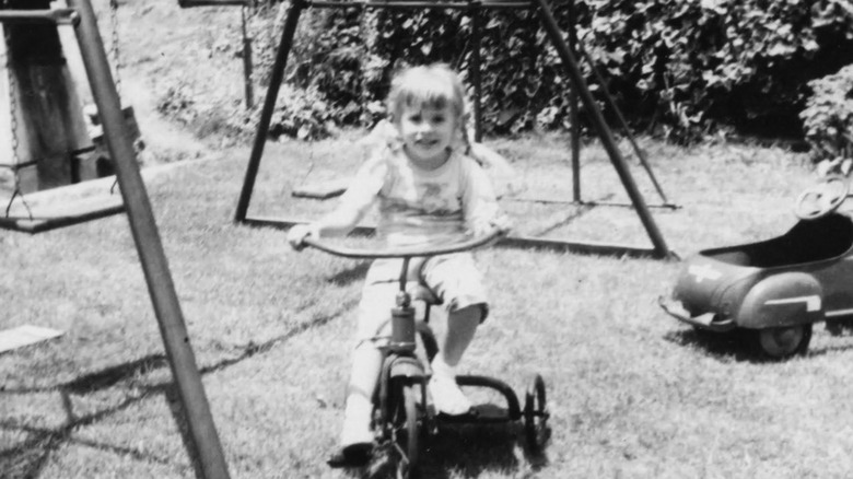 Stevie Nicks as a child riding a tricycle