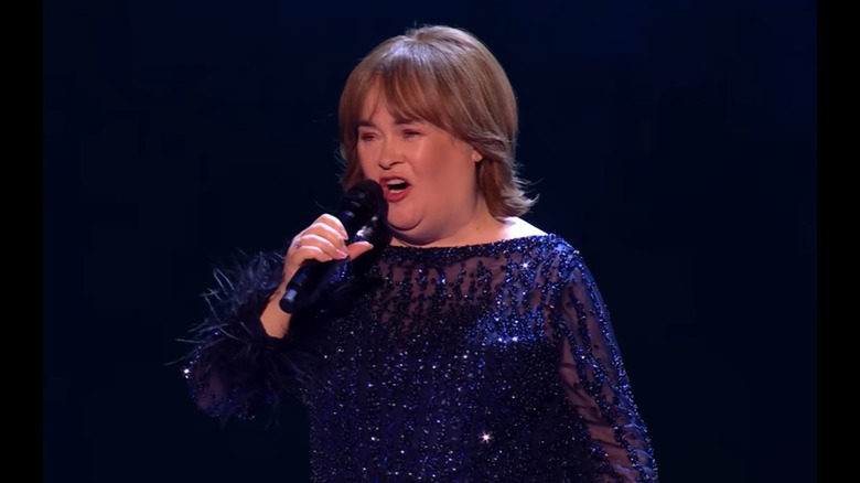 Susan Boyle smiling and singing