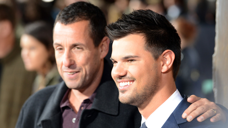 Adam Sander and Taylor Lautner smiling together