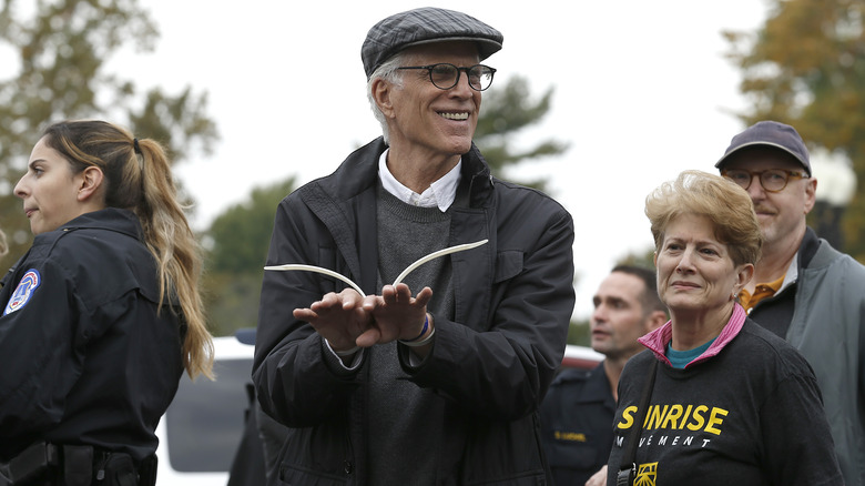 Ted Danson smiling while getting arrested