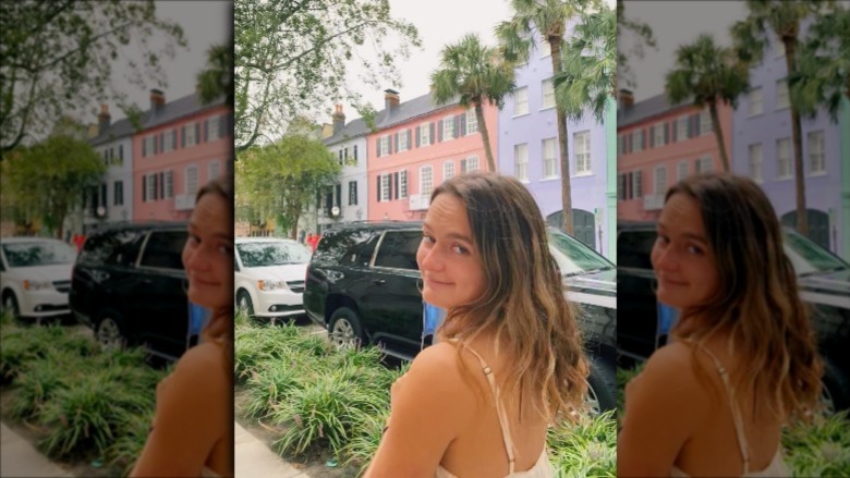 Zoe Roth in front of a row of houses