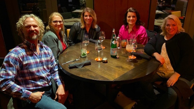 Kody Brown seated with his four wives, Christine, Meri, Robyn, and Janelle