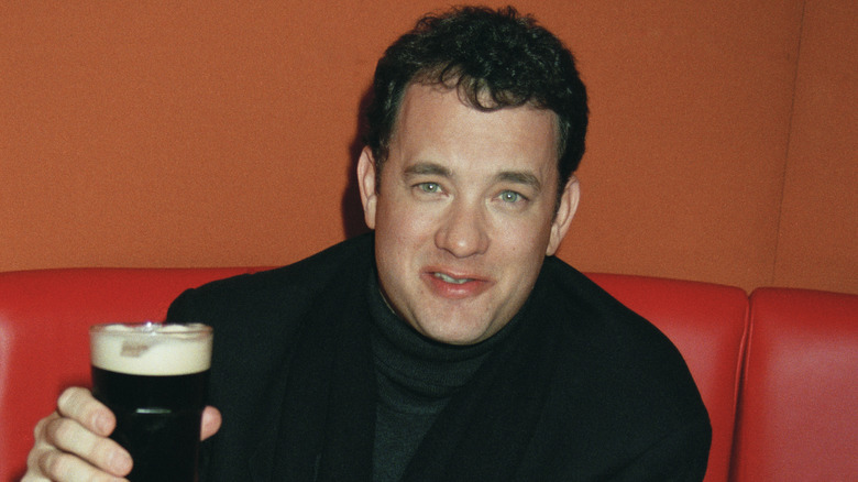 Tom Hanks, holding a glass of beer