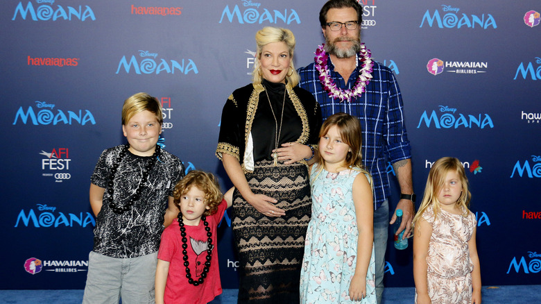 Tori Spelling poses at an event with her family