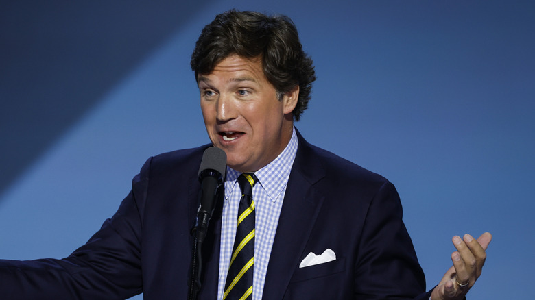 Tucker Carlson speaking on stage on the fourth day of the 2024 Republican National Convention at the Fiserv Forum