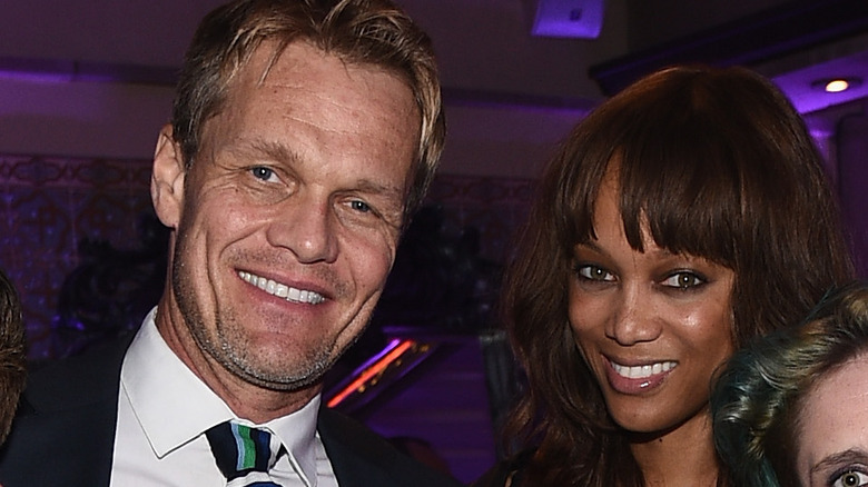 Erik Asla and Tyra Banks, both smiling