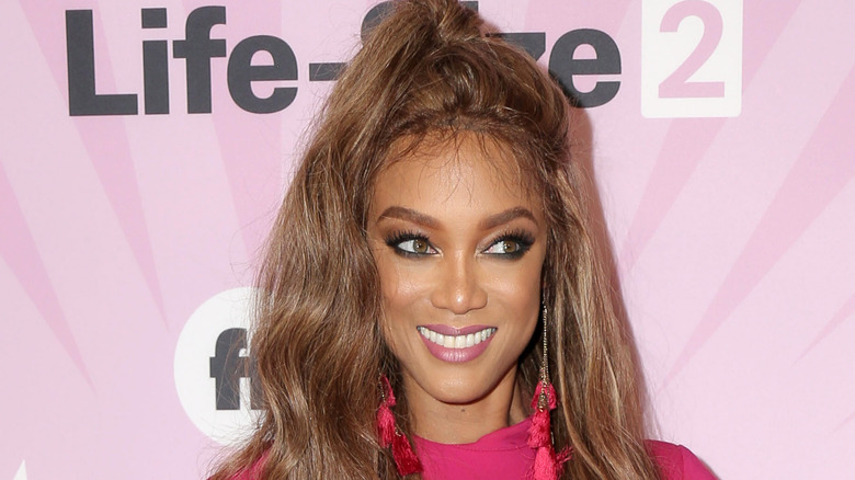 Tyra Banks in pink, smiling