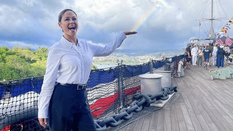 Vanessa Lachey holding hand in front of rainbow