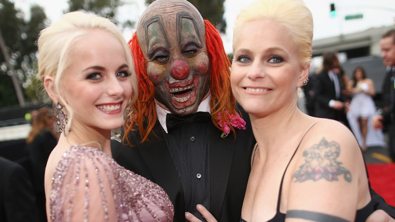 Gabrielle Crahan posing with her parents 