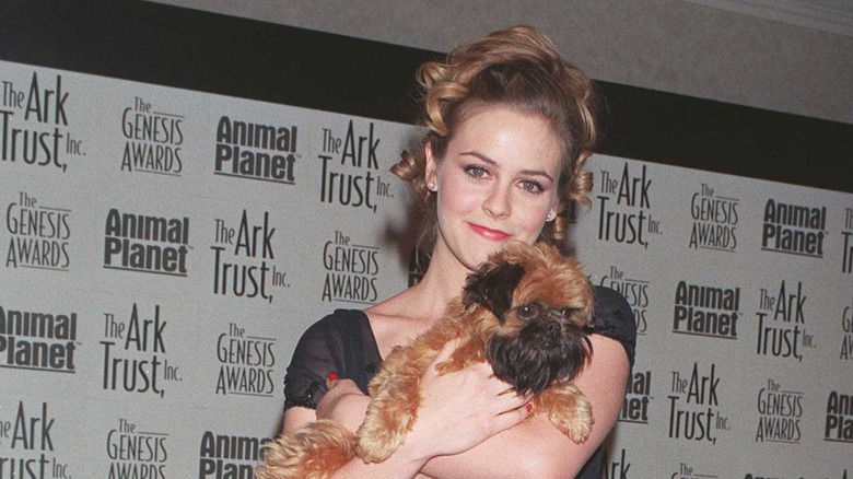 Alicia Silverstone holding a dog