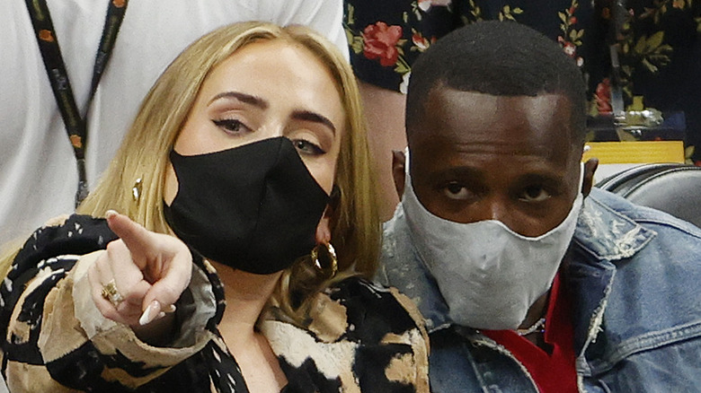 Adele and Rich Paul sitting and wearing face masks