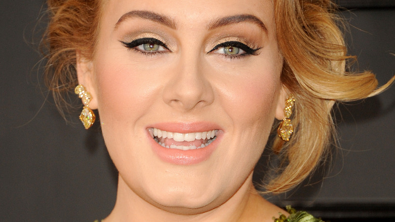 Adele with wide smile and updo at the Grammy Awards