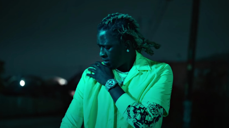 Young Thug with his hand on his shoulder