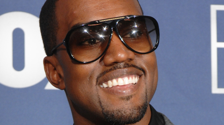 Kanye West smiling on the red carpet 