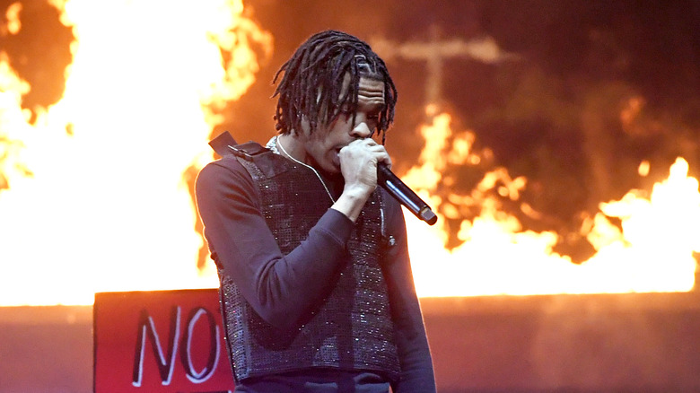 Lil Baby performing in front of flames