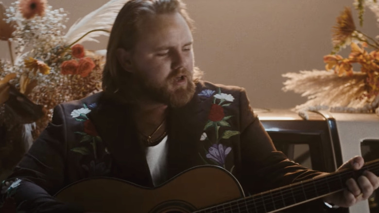 ERNEST playing a guitar