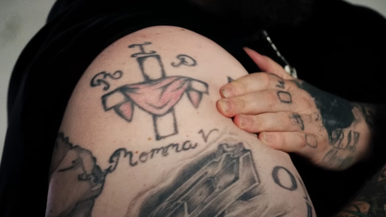 cross tattoo on Jelly Roll's shoulder