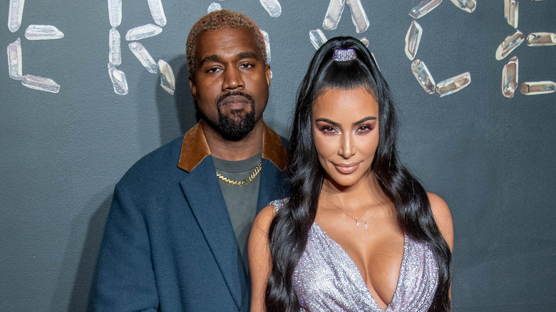 Kanye West and Kim Kardashian pose at an event