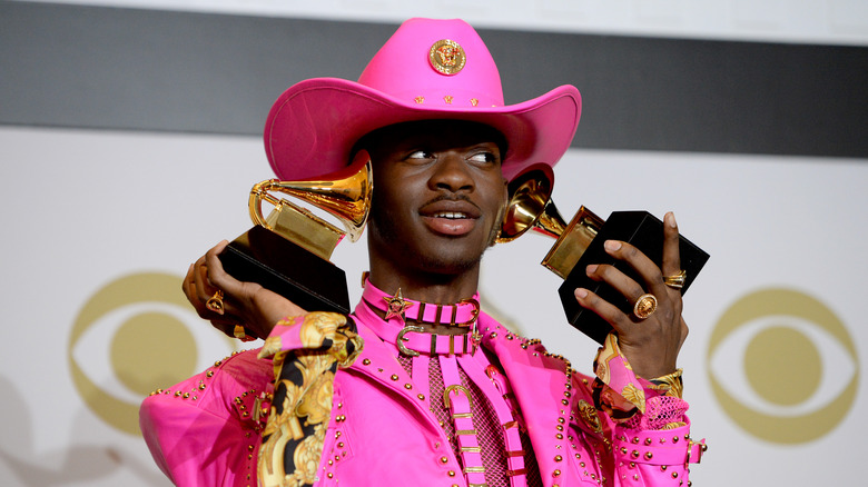 Lil Nas X holding Grammy Awards