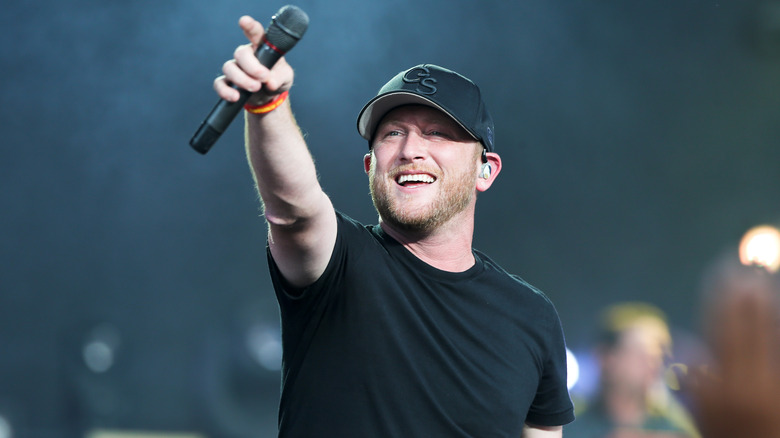 Cole Swindell performing with microphone