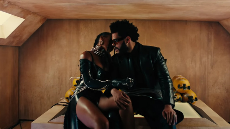 a woman and The Weeknd getting close