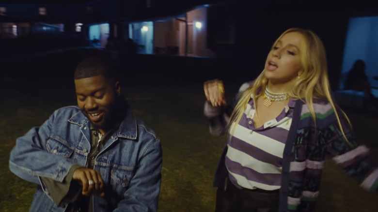 Khalid and Tate McRae, singing together, screenshot of their music video for "Working"