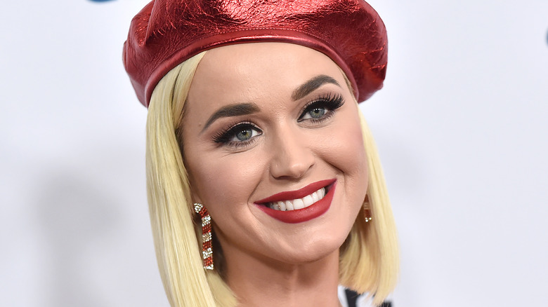 Katy Perry wearing a red hat