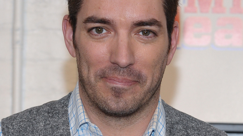 Jonathan Scott with scruff gray suit