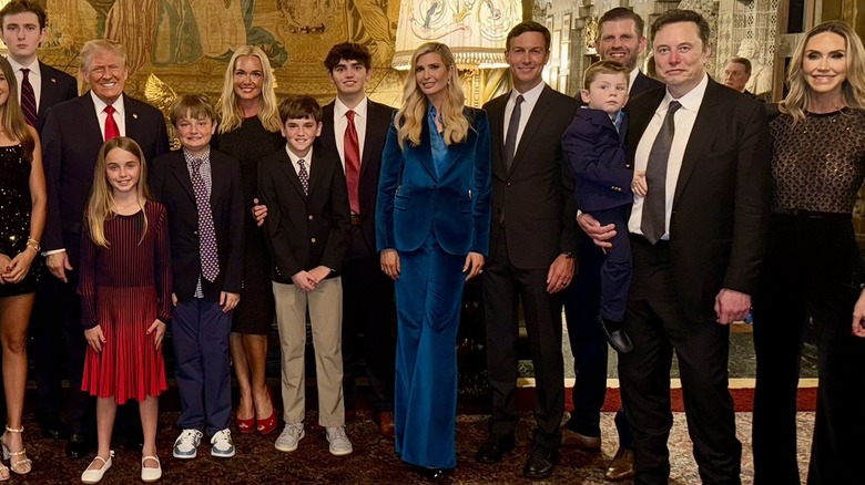 Ivanka Trump wearing blue velvet pantsuit while posing with her family and Elon Musk at Mar-a-Lago