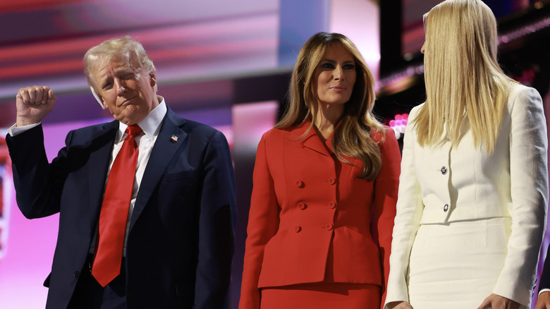 Donald Trump raising a fist beside Melania Trump and Ivanka Trump at the 2024 Republican National Convention