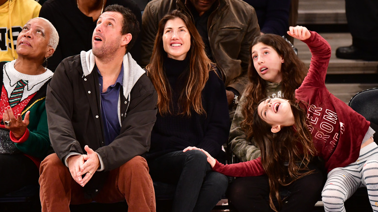 Adam Sandler with his family, seated, all looking up