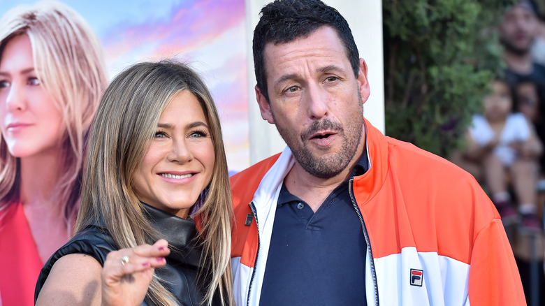 Adam Sandler with costar Jennifer Aniston, both posing