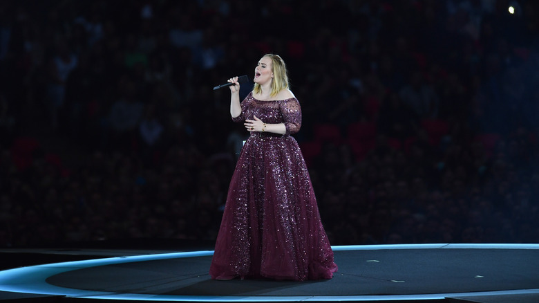 Adele performs in a purple dress