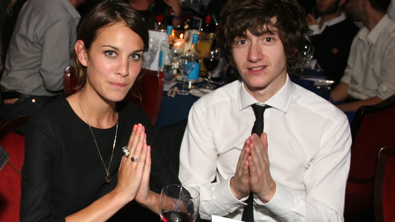 Alexa Chung and Alex Turner put their hands together