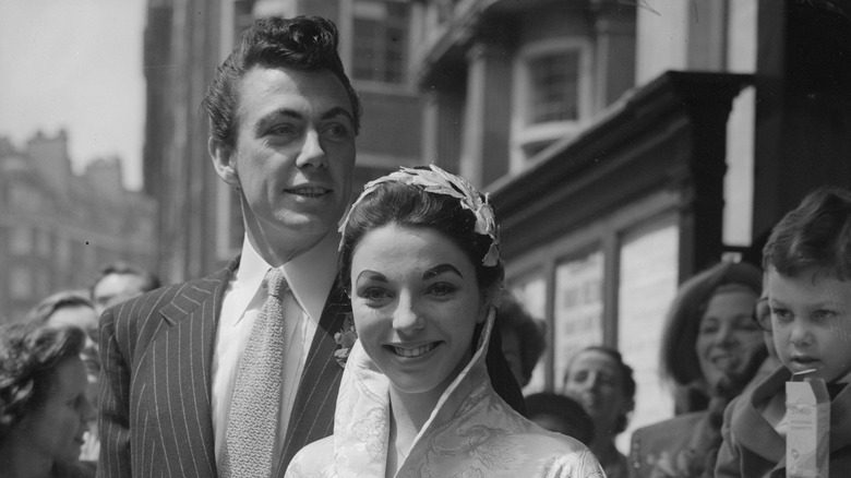 Joan Collins and Maxwell Reed posing together