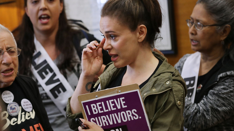 Alyssa Milano and several dozen other protesters listen to sexual assault survivors as they tell their stories the office of Sen. Cindy Hyde-Smith