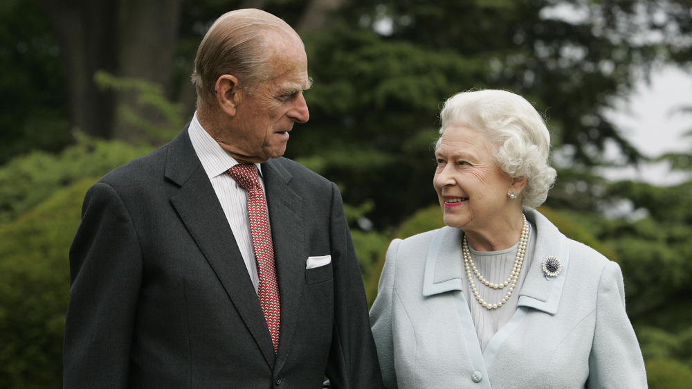 Prince Philip and Queen Elizabeth II smile at each other 