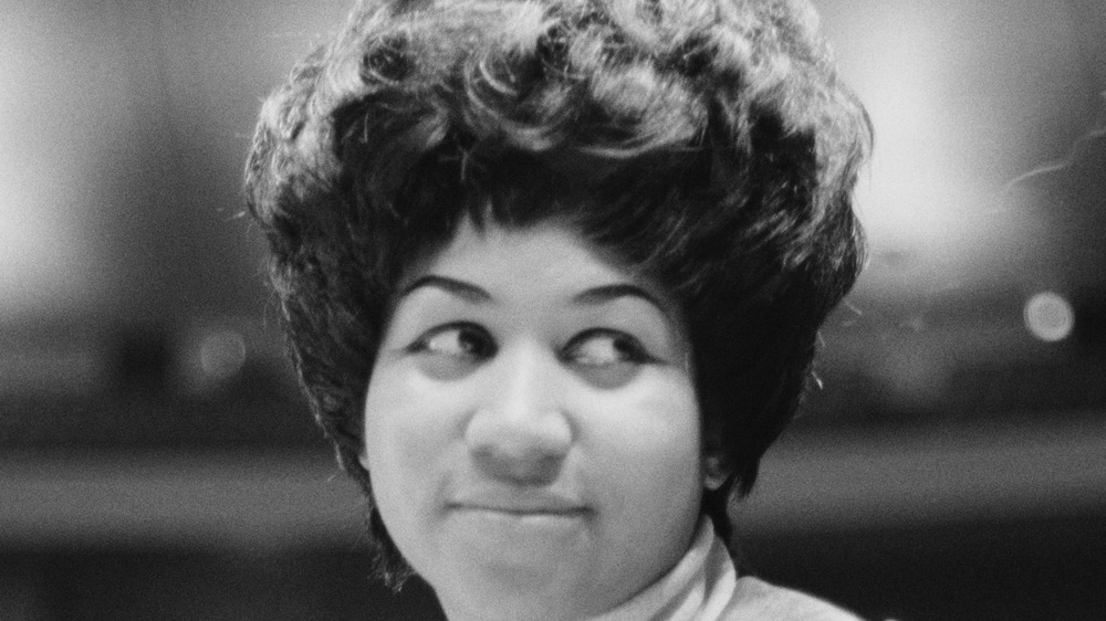 Aretha Franklin giving side-eye and smiling