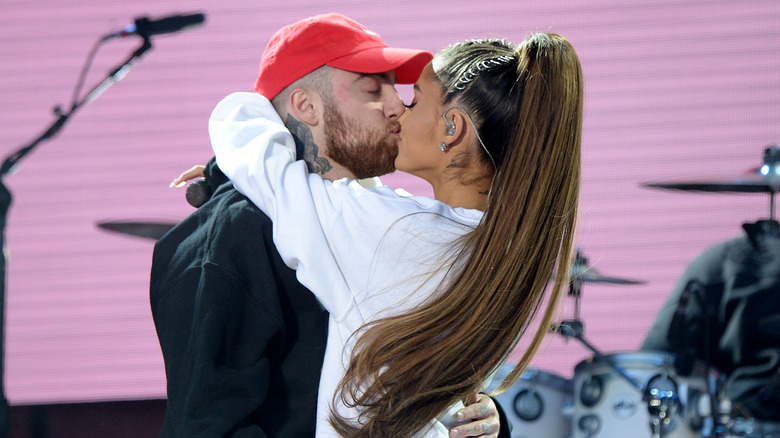 Mac Miller and Ariana Grande kissing onstage