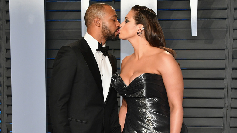 Justin Ervin and Ashley Graham kiss at event