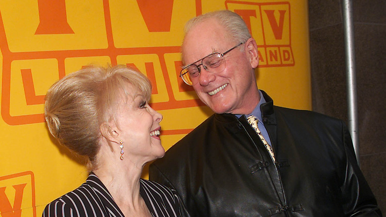 Barbara Eden and Larry Hagman smile at each other at a TV Land event