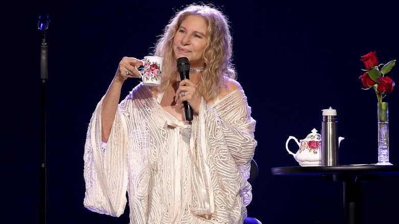 Barbra Streisand sipping tea on stage
