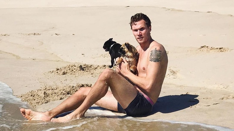 Barron Hilton and dogs on beach